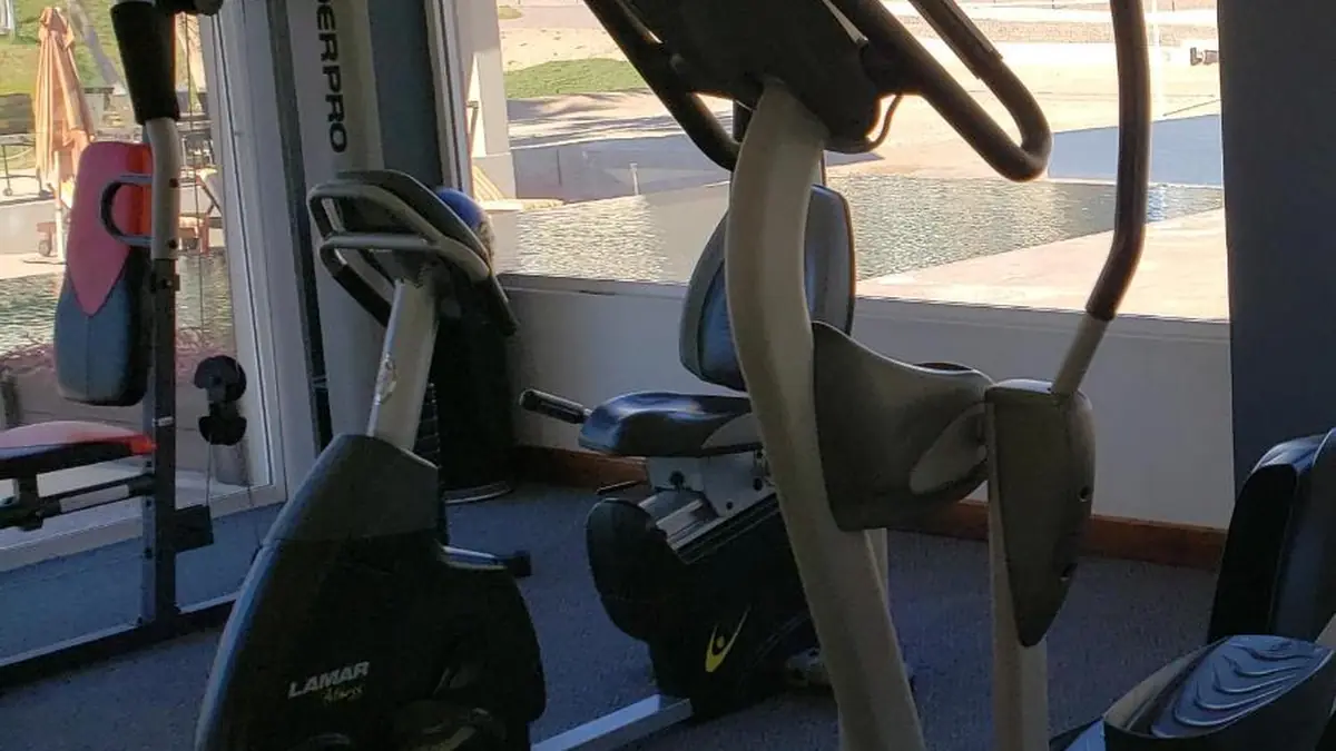 The condominium’s gym, with exercise bikes and an elliptical by the picture window